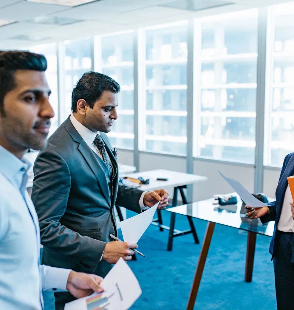 Business professionals reviewing documents together in a modern office